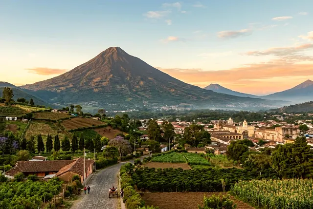 El Volcán de Agua al atardecer sobre los tejados y cultivos de Antigua Guatemala